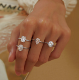 four solitaire engagement rings on hand
