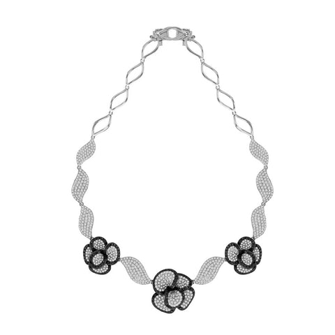 white gold flower necklace with black and white diamonds