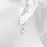 white gold swirled diamond drop earrings