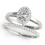 platinum single row diamond wedding band and platinum oval halo engagement ring