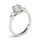 white gold three stone diamond engagement ring with baguettes and a round center diamond