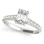 platinum single row diamond engagement ring with an emerald cut diamond