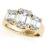 yellow gold three stone emerald cut engagement ring 