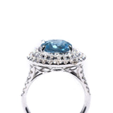 18kt white gold blue topaz ring with a double halo of diamonds  