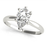 white gold solitaire engagement ring with a pear shaped diamond
