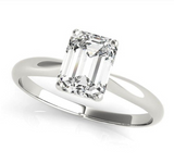 white gold solitaire engagement ring with an emerald cut diamond